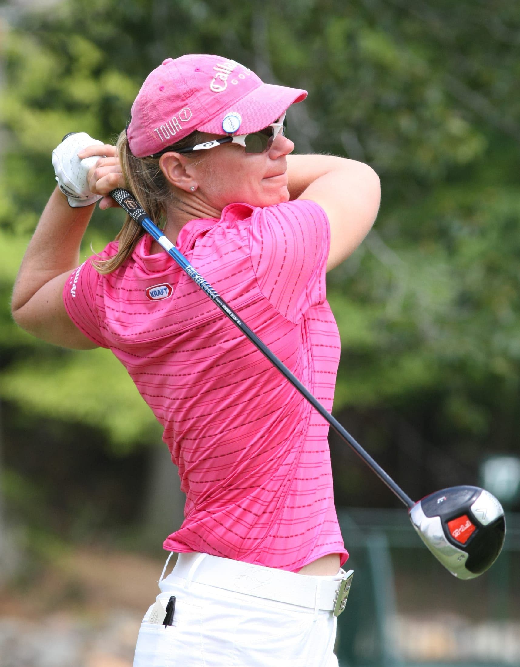 Annika Sorenstam completing her swing in pink tournament apparel