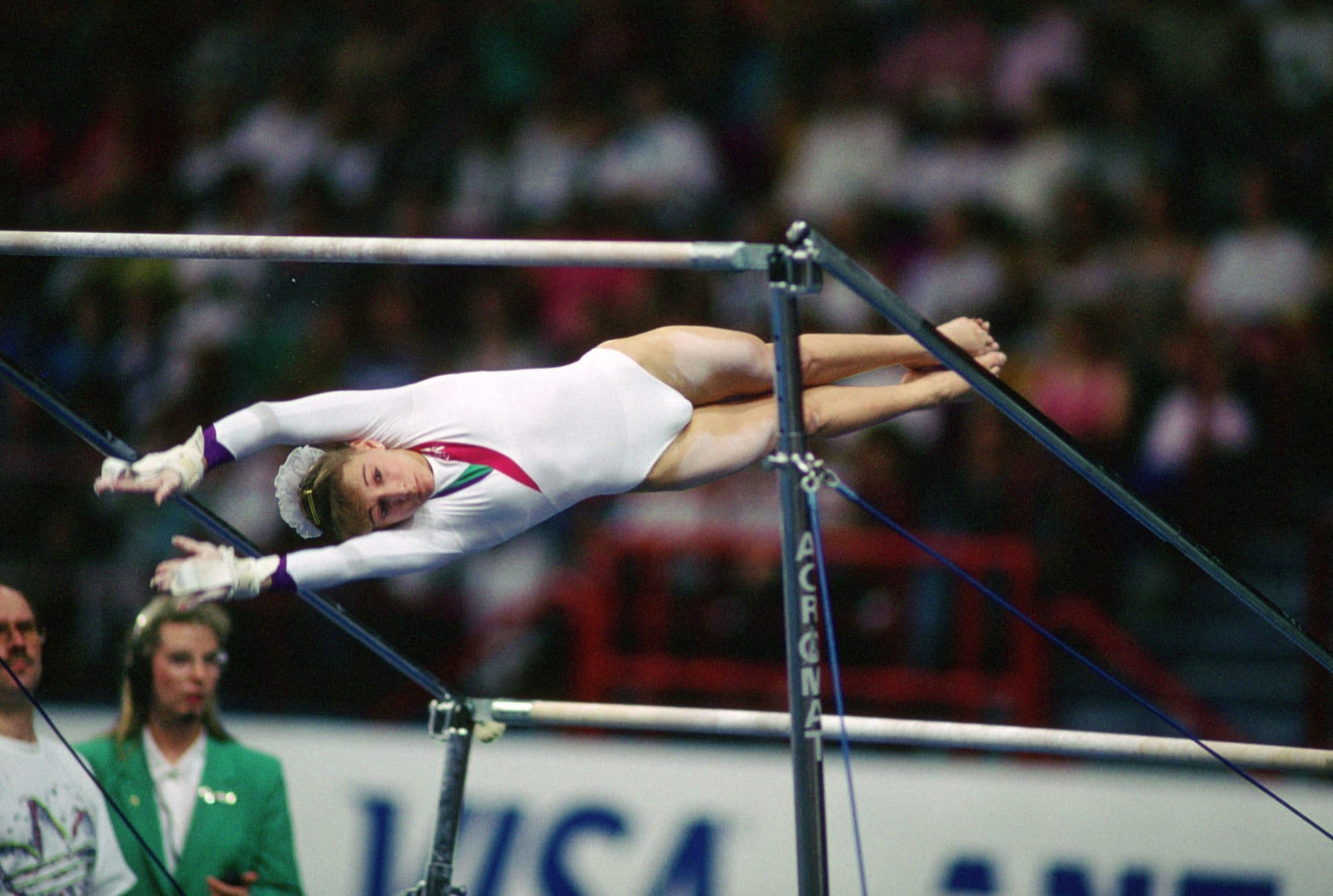 A USA gymnast competing on the uneven bars