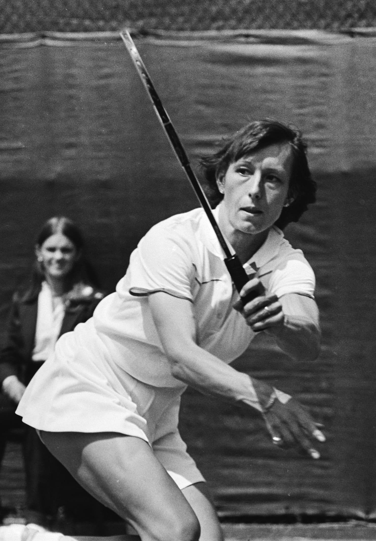 A tennis player following through on a backhand shot, early 1980s