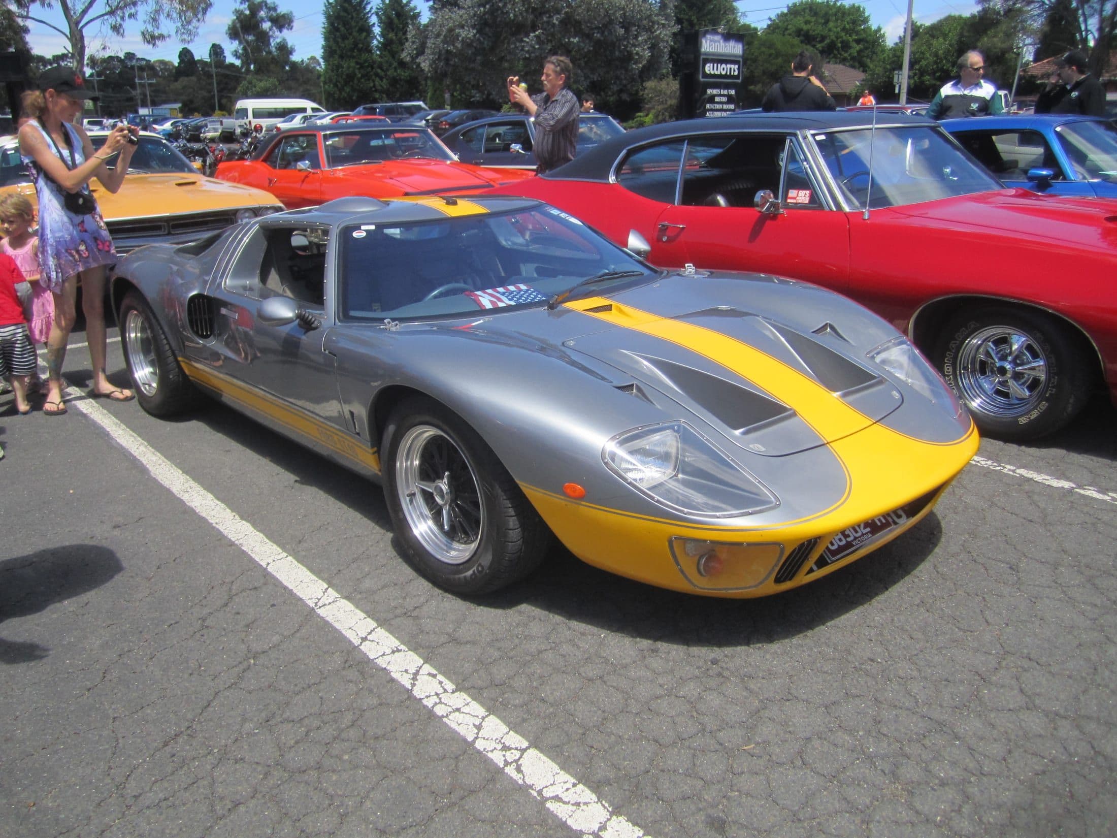 A Ford GT40 in period silver and yellow livery on display